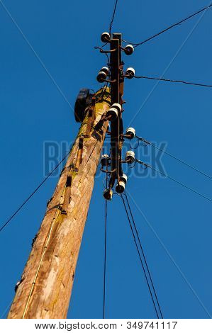 Electricity Pylon.  A Wooden Electricity Pylon With Cables.