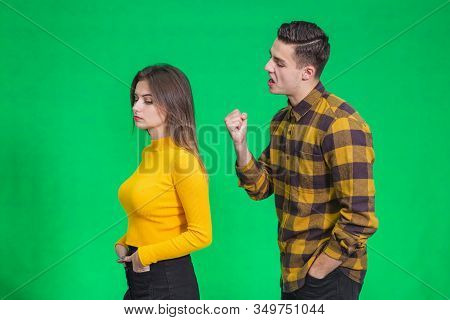 Man Extremely Angry At Girlfriend, Shouting At Her, Warnig With Fist, She Stands Back To Her, Not Pa