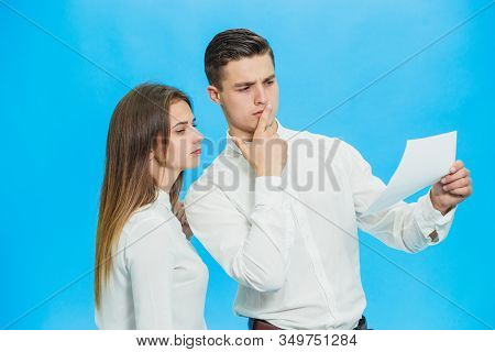 Serious Director And His Assistant Checking Documentation And Looking For Mistakes Over Blue Backgro