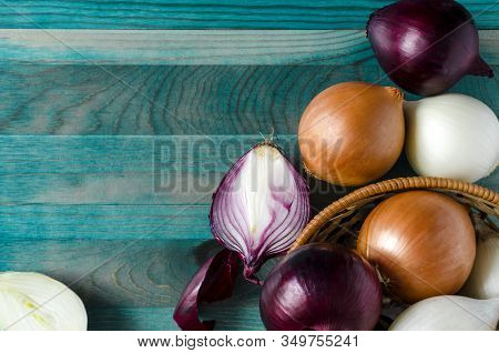 Large Juicy Red, Yellow And White Onion Bulbs In A Basket Close-up View From Above