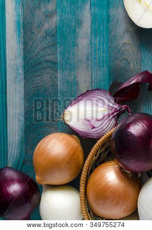 Large Bulbs Of Yellow, Red And White Onions Close-up In A Wicker Basket