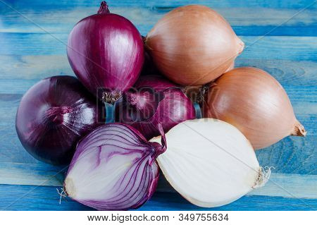Large Yellow And Red Onion Bulbs In Close-up On A Natural Blue Background
