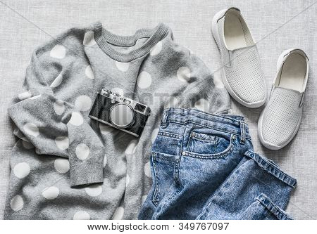 Women's Spring Clothes - Mom's Jeans, Grey Polka Dot Pullover, Sneakers Shoes And Foto Camera On A G