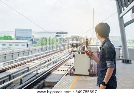 Bangkok Thailand, April 7,2019 : Asian Man Passenger Using Smartphone And Looking Bts In Train Stati