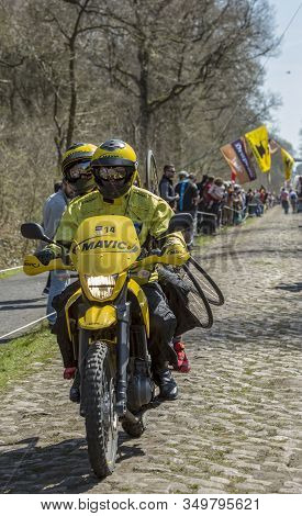 Wallers,france - April 12,2015: The Yellow Technical Bike Of Mavic Driving On The Famous Cobblestone