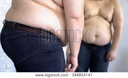 Depressed Obese Man Looking At Fat Belly Mirror Reflection, Weight Loss Problem