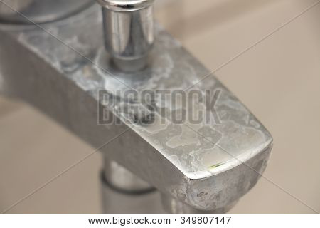 Close-up Of Shower Mixer Faucet With Limescale, White Chalky Deposit And Stains. Formed On The Plumb