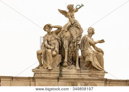 Gerlitz, Germany - April, 2019: Statues On The Roof Of The City Post Office Building, A Monument Of 