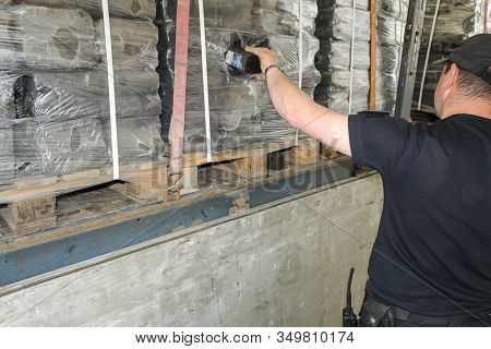 Krakovets, Ukraine - May, 2019: The Border Guard In Special Uniform Extracts Smuggling Cigarette Pac