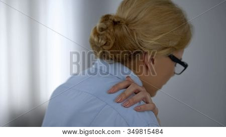 Female Office Worker Suffering From Shoulder Pain, Overworked, Sedentary Life