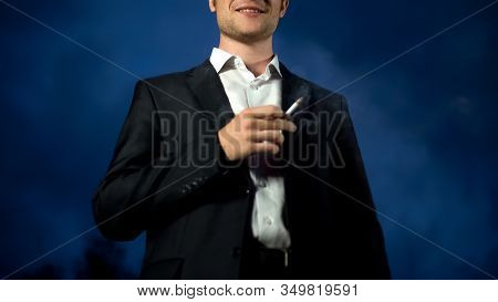 Self-confident Fraudster Smiling Smoking Cigarette, Successful Scam, Criminality