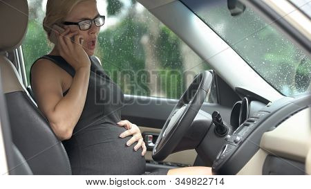 Worried Pregnant Female Calling Ambulance, Sitting In Car, Early Parturition