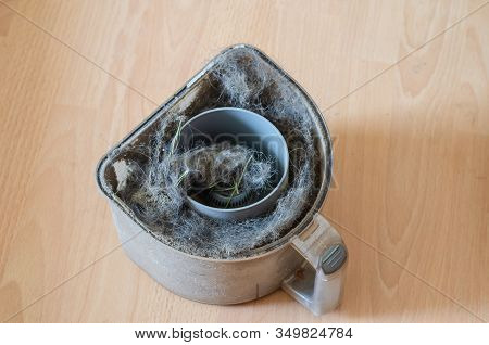 Vacuum Cleaner Garbage Container Full Of Dust And Dirt. Full Vacuum Cleaner On The Floor. Indoor Cle