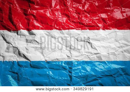 National Flag Of Luxembourg
 On Crumpled Paper. Flag Printed On A Sheet. Flag Image For Design On Fl