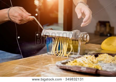 Chef Rolling Dough With A Pasta Machine. Pasta Maker Machine.