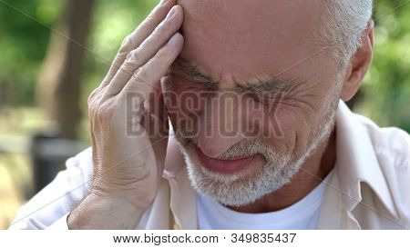Senior Man Suffering Headache, Migraine Attack During Walk, Risk Of Thrombus