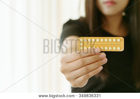 Woman Holding Contraception Pills At Home, Closeup. Gynecology Concept