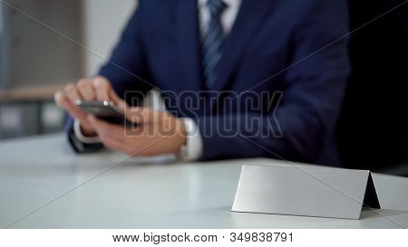 Businessman Reading E-mail On Smartphone, Blank Nameplate Template For Text