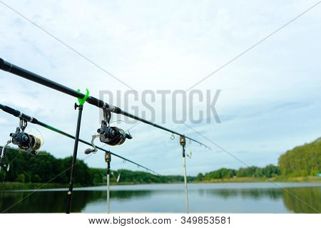 Carp Fishing On Beautiful Blue Lake With Carp Rods And Rod Pods In The Summer Morning. Fishing From 