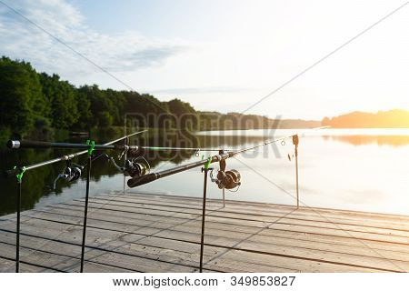 Carp Fishing On Beautiful Blue Lake With Carp Rods And Rod Pods In The Summer Morning. Fishing From 