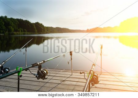 Carp Fishing On Beautiful Blue Lake With Carp Rods And Rod Pods In The Summer Morning. Fishing From 