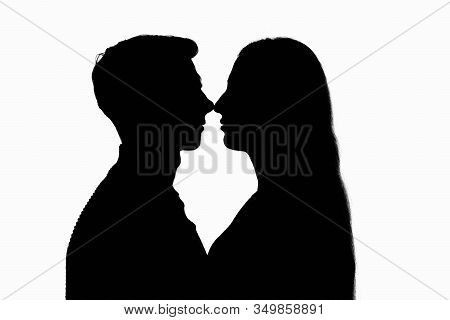 Two People In A Counterlight Touched Each Other With Their Noses