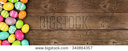 Colorful Easter Egg Banner With Side Border Overt A Rustic Old Wood Background. Overhead View With C