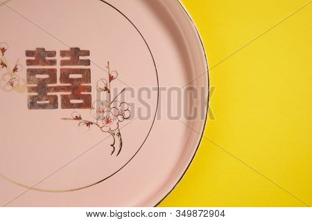 Teapot and cups used in traditional Chinese wedding ceremony with chinese sign meaning happinese. Translation: Double Happiness