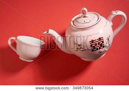 Teapot and cups used in traditional Chinese wedding ceremony with chinese sign meaning happinese. Translation: Double Happiness