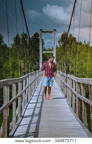 Muko Chumphon National Park, Thailand , Men Walking On Wooden Deck In The Park With Trees And Mangro