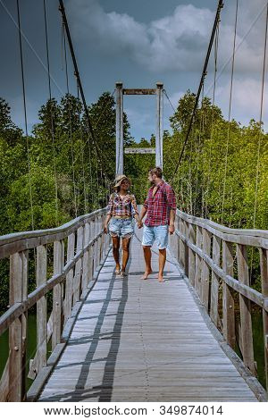 Muko Chumphon National Park, Thailand , Couple Walking On Wooden Deck In The Park With Trees And Man
