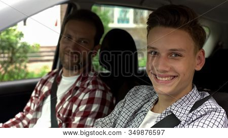 Young Driver And His Father Smiling Into Camera, Teen Getting Driving License