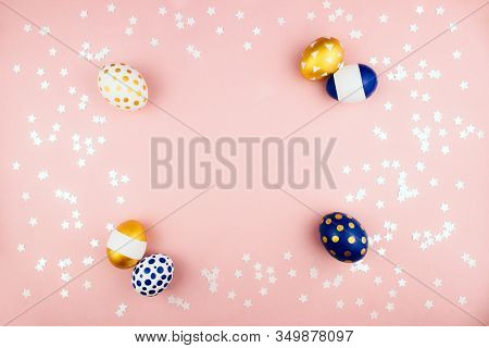 Modern Trendy Golden And Blue Spring Easter Eggs Flat Lay On Colorful Pink Background With Stars Con