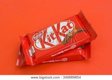 Kit Kat Chocolate Bar In Red Wrapping Lies On Red Background. Kit Kat Created By Rowntrees Of York I