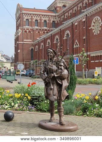 Albert, Somme, France - May 1, 2019. Bronze Figure Of A Scottish Piper In Front Of Basilica And Somm