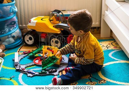 Poznan, Poland - January 19, 2020: Two Years Old Caucasian Polish Boy Sitting On A Carpet Floor Play