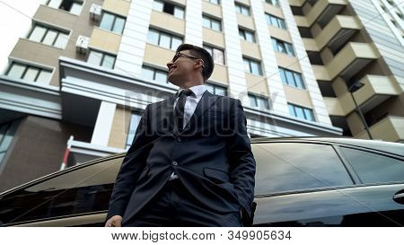Smiling Businessman Standing Near Premium Class Auto, Saving Money, Banking