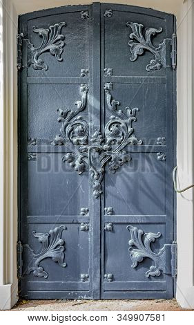 Close-up Of Ancient Vintage Double Metal Door With Cast Iron Floral Deorative Ornament