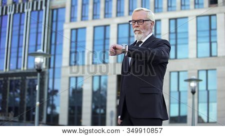 Senior Boss Waiting Young Secretary Looking Watch, Unpunctual Business Partner