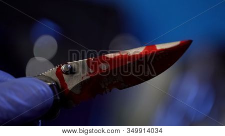 Forensic Examination Of Knife With Blood, Conclusive Evidence, Hand Closeup