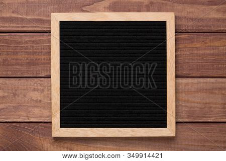 Empty Black Letterboard On Wood Background. Design Mockup