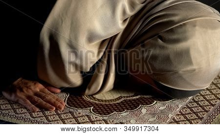 Woman In Hijab Prostrating On Prayer Rug, Obligatory Religious Ritual, Worship