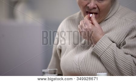 Crying Aged Woman Taking Pills, Suffering From Incurable Disease, Hospital