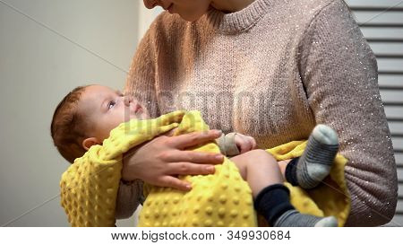 Young Mommy Holding Adorable Newborn Baby In Arms And Admiring Him, Love