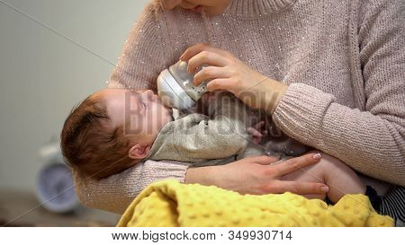 Babysitter Feeding Cute Little Child From Bottle, Artificial Feeding Accessories