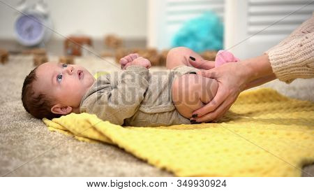 Lady Massaging Baby Legs, Thigh Joints Dysplasia Prevention, Reducing Colic Pain