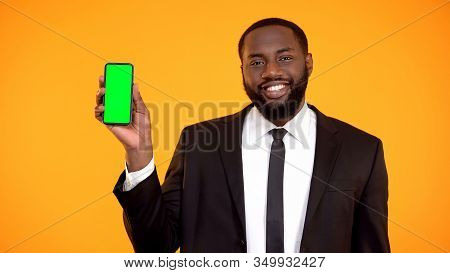 Friendly Handsome Afro-american Man In Suit Showing Prekeyed Phone, Template