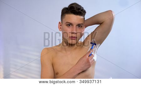 Teen Student Shaving Armpit Using Cream And Safe Blade, Daily Self-care Rituals
