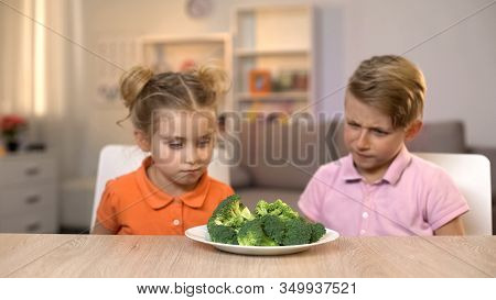Two Children Looking At Broccoli, Unappetizing Meal, Tasteless Healthy Food