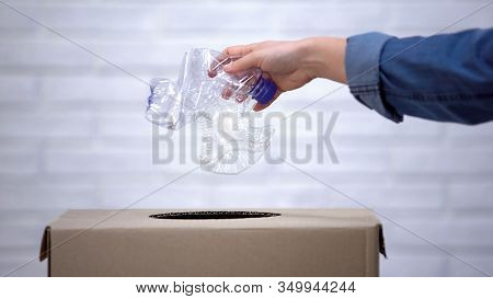 Hand Throwing Plastic Bottles Into Trash Bin, Sorting Non-degradable Waste